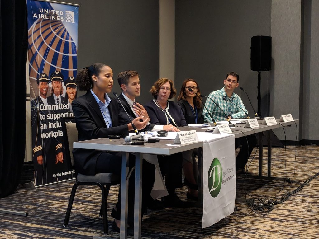 A side view photo of a panel of speakers at the 2018 UAIA event